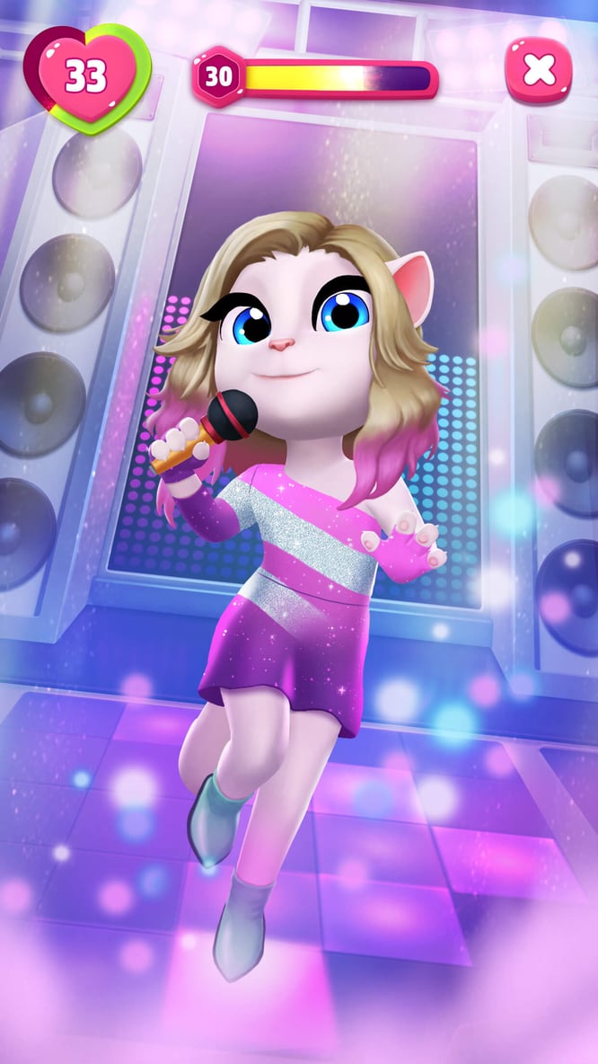 Talking Angela singing on stage inside of My Talking Angela 2 game.