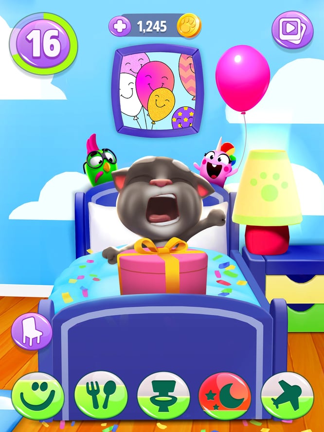 Talking Tom waking up to a surprise birthday party thrown by pets inside of My Talking Tom 2 game.