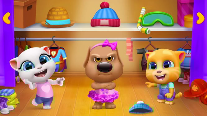 Talking Ben being grumpy dressed in a tutu while Talking Angela and Ginger are laughing at him inside of My Talking Tom Friends game.